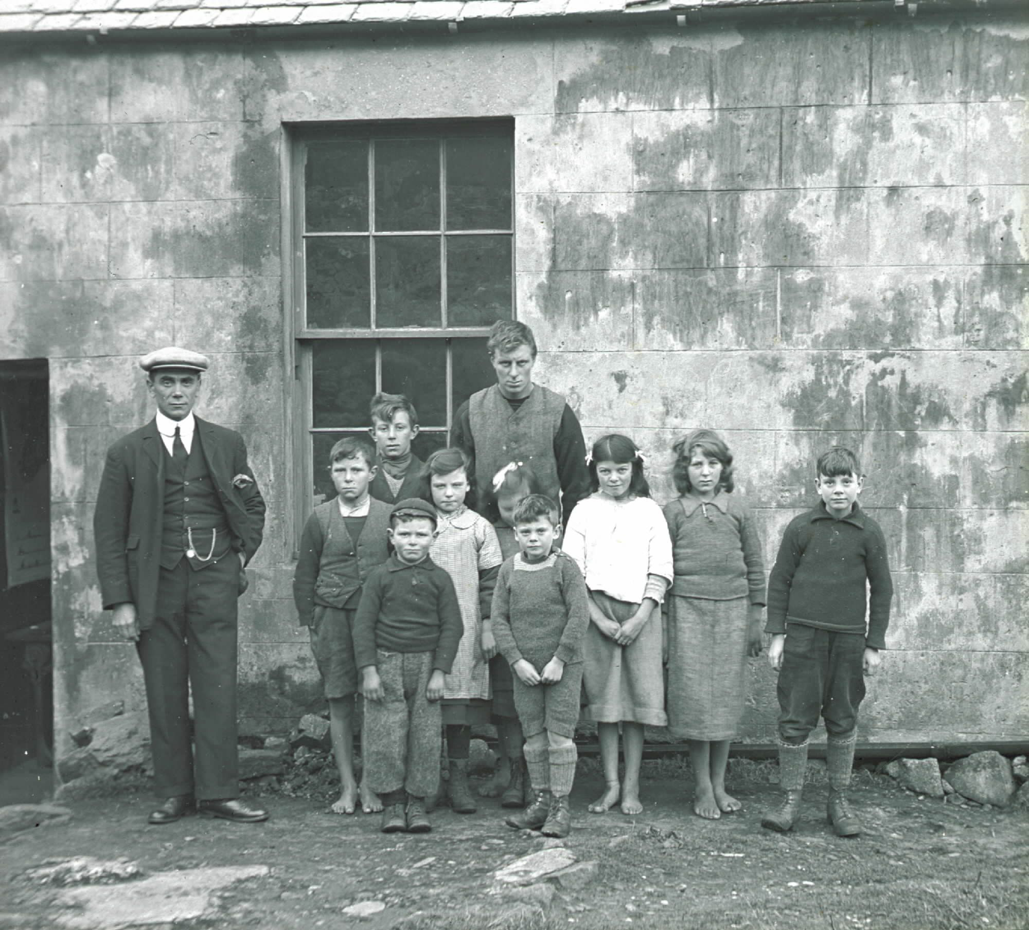 Fig. 9: Glass plate negative of barefoot school children outside the school building, #99 © National Trust for Scotland, St Kilda