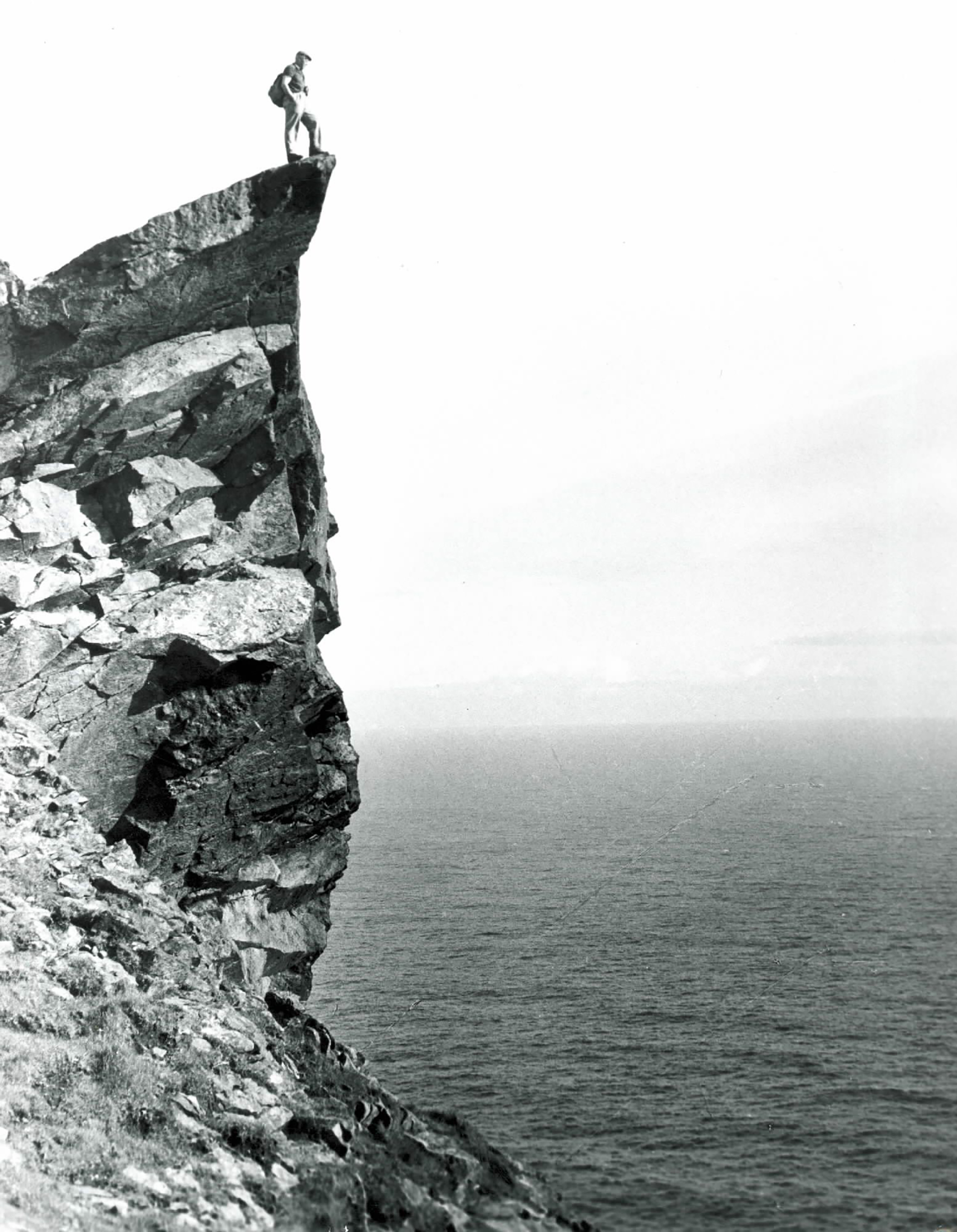 Fig. 6: Glass plate negative of a man on the Lover’s Stone, Hirta, #352 © National Trust for Scotland, St Kilda