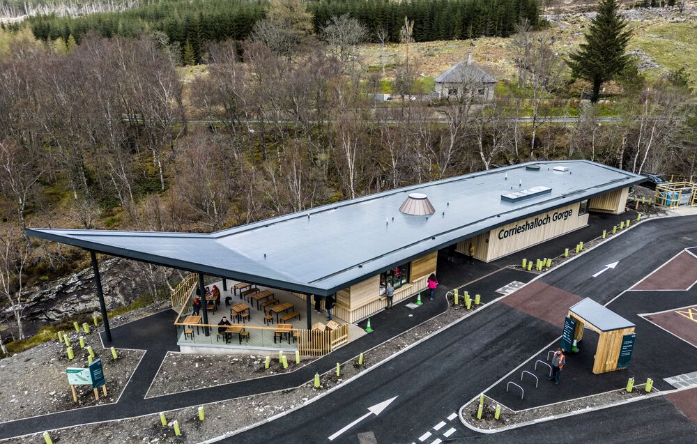 An aerial view of a newly built visitor centre at Corrieshalloch Gorge. It shows the access road, ticket booth and newly laid paths surrounding the centre.