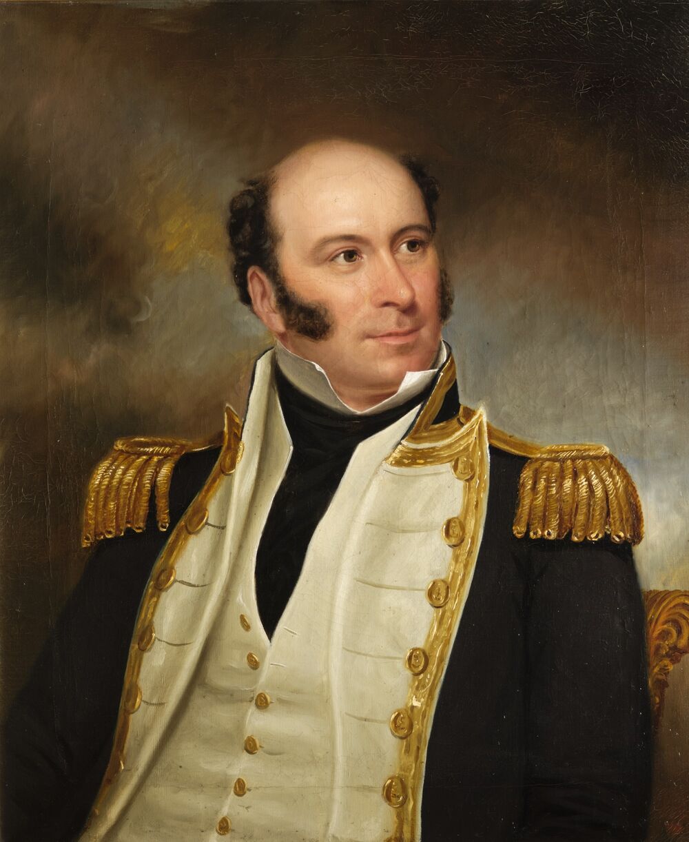A half portrait of a middle-aged man in naval uniform. He has dark sideburns although is bald on top. He wears a navy jacket with gold trimmings, and a white waistcoat underneath.