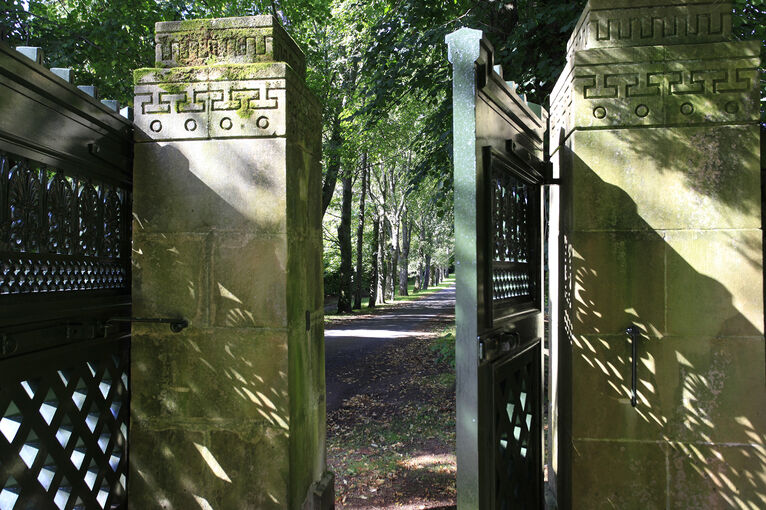 The garden gate lies open to the riverside grounds at Holmwood.