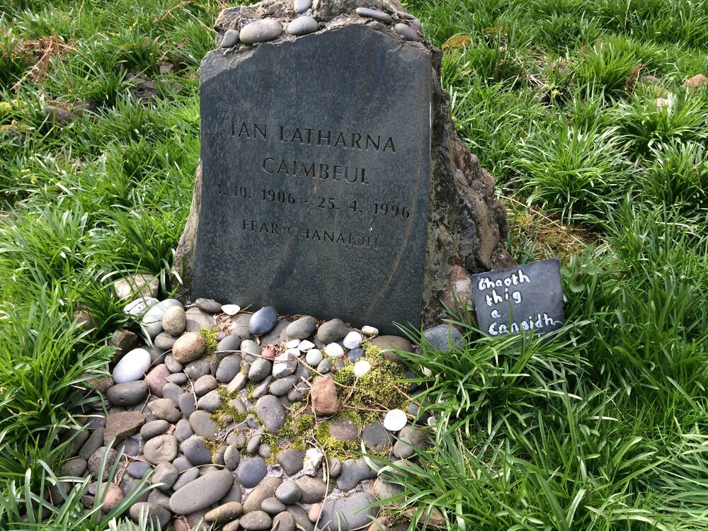 Gravestone of John Lorne Campbell, with pebbles in front of it.