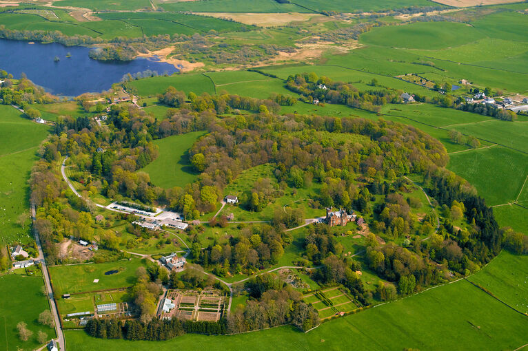 A bird’s-eye view of Threave Garden, showing the formal garden areas surrounded by woodland, farmland and the River Dee.