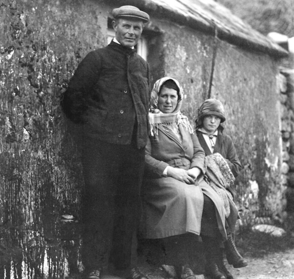 Margaret took several photos during her visit to St Kilda, including this one of a family outside one of the cottages on The Street