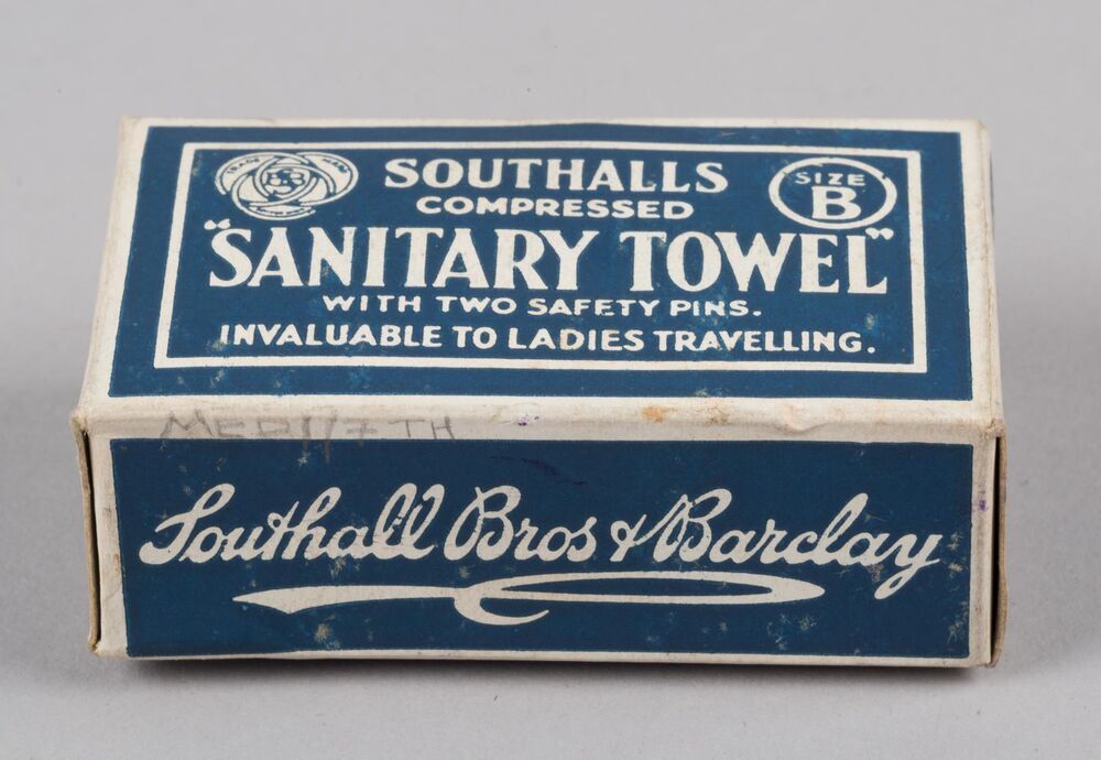 A blue and white box of Southalls compressed sanitary towel with two safety pins. The strapline reads 'invaluable to ladies travelling'.