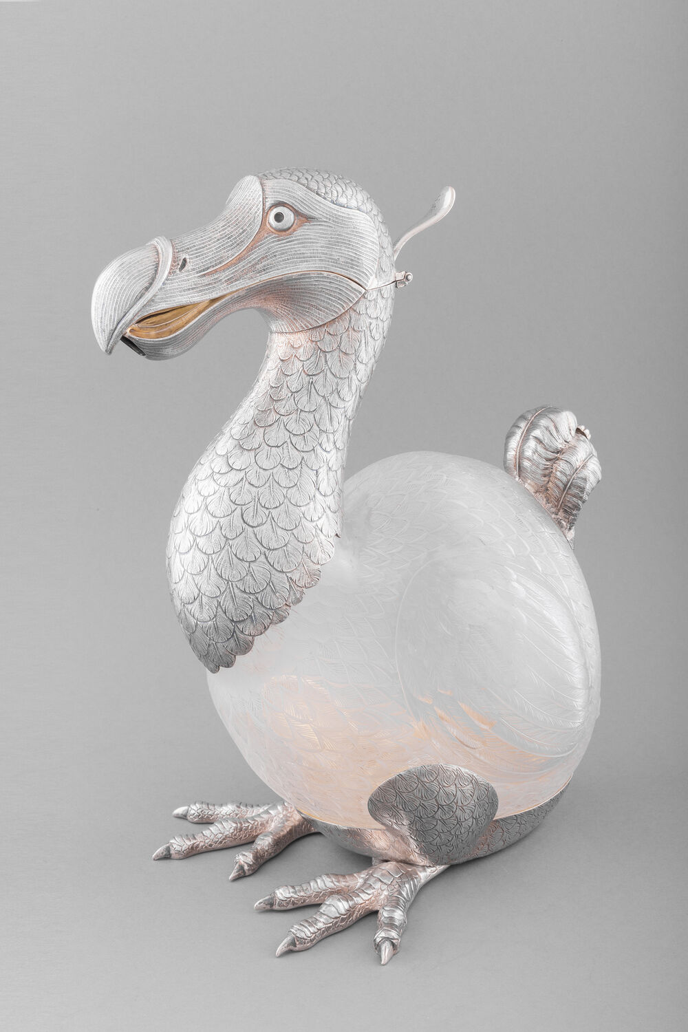 A silver wine jug, shaped like a dodo. The hinged beak opens to pour the wine through.