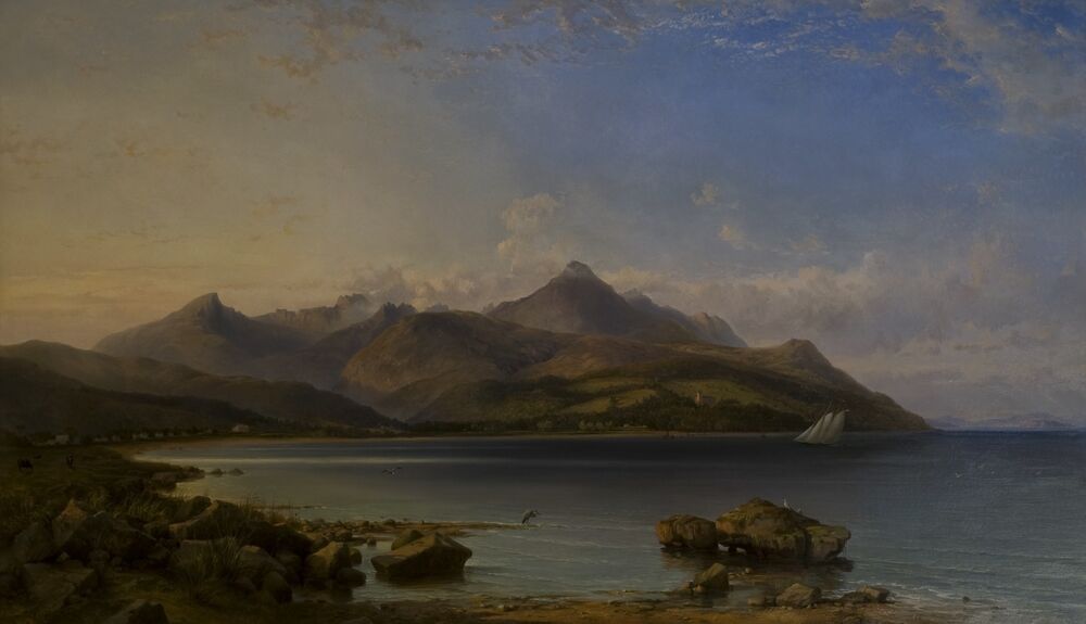 An oil painting of Brodick Bay, looking north across the bay to the castle and the towering mountains behind. A heron stands on the shore in the foreground, and a white-sailed boat is in the middle of the bay. The sea and sky are blue, with an orange haze to the west.