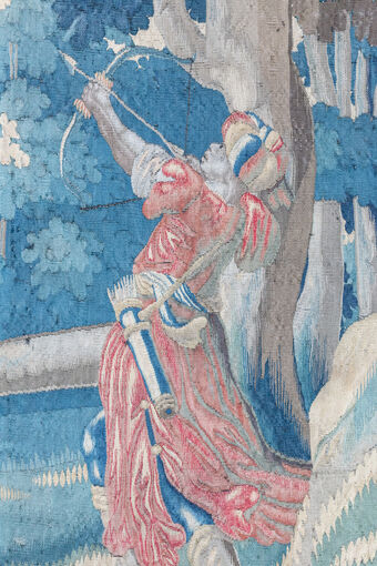 Detail in a tapestry of an archer, after cleaning