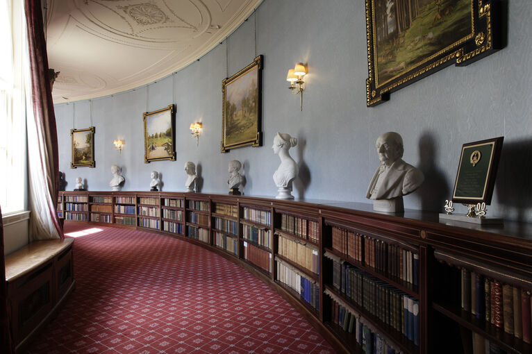Paintings, busts and books line the red-carpeted Quadrant Corridor in Haddo House