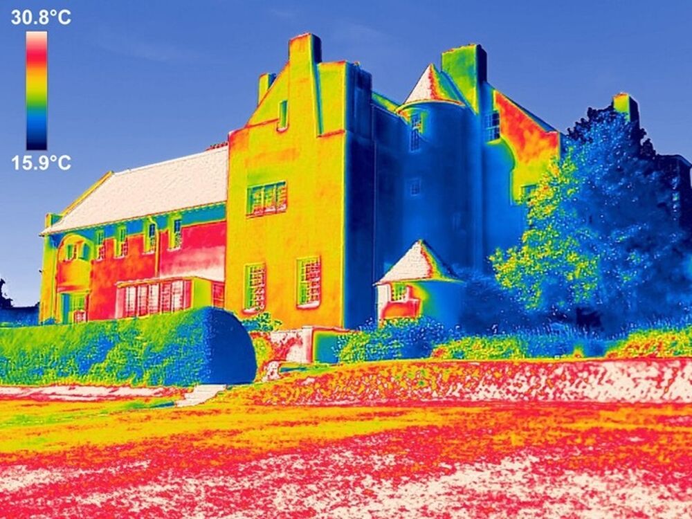 A thermographic image of the exterior walls of a house, showing the temperature ranges across different parts of the building.