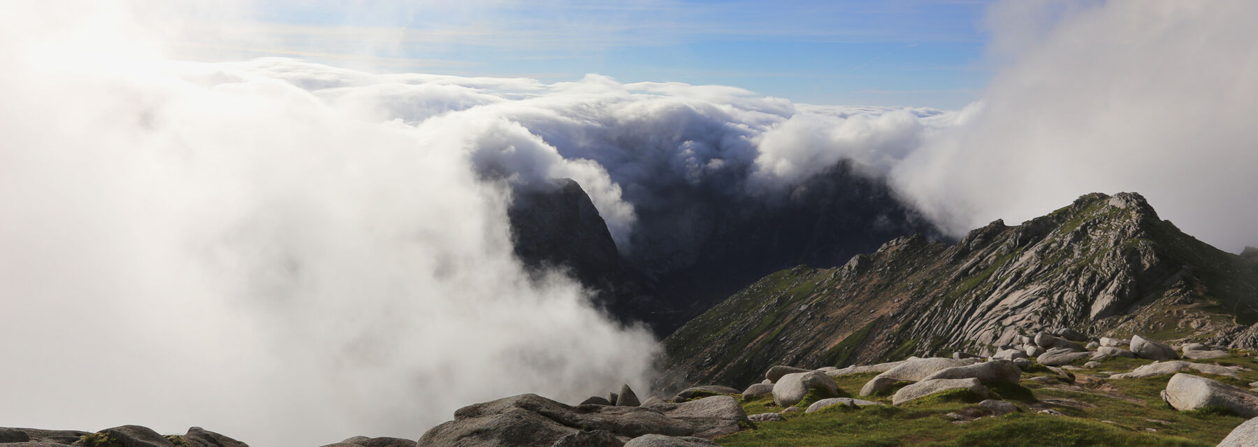 The summit of Goat Fell on Arran, seen with white clouds swirling around.