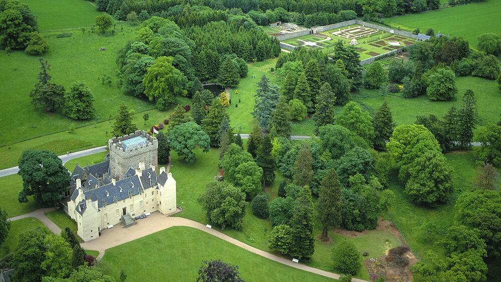 Aerial view of Drum Castle and surrounding woodland