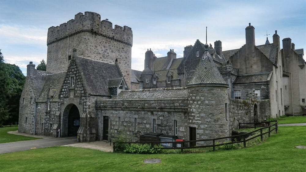 A close-up view of the exterior of Drum Castle, looking at the Old Tower and courtyard in the foreground.