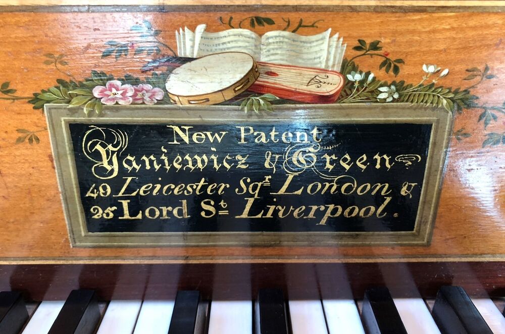 A black label is found on the wood above some piano keys. The label reads: New Patent, Yaniewicz Green, 40 Leicester St, London | 26 Lord St, Liverpool.
