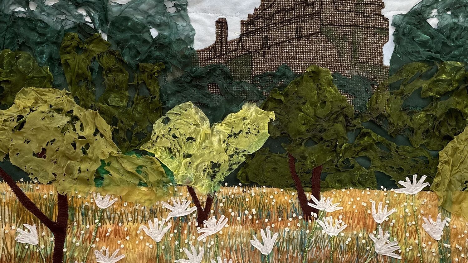 A composite artwork depicting an orchard with Falkland Palace rising beyond. The palace is stitched in brown thread, but the trees are made out of a fine fabric, directly applied to the canvas. The daisies in the foreground are made from white felt stitched onto the canvas, with bright yellow buttons at the centre.